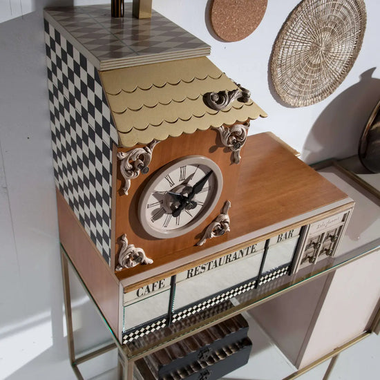 Detalle del Aparador Manhattan con reloj decorativo, vitrina, motivos en damero y estructura metálica