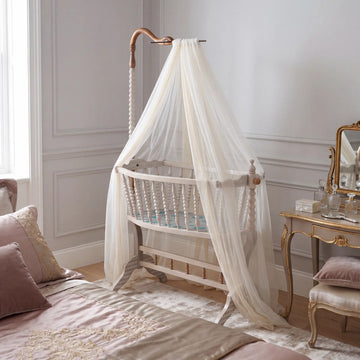 Cuna Bambino en dormitorio infantil elegante con dosel de tela ligera.