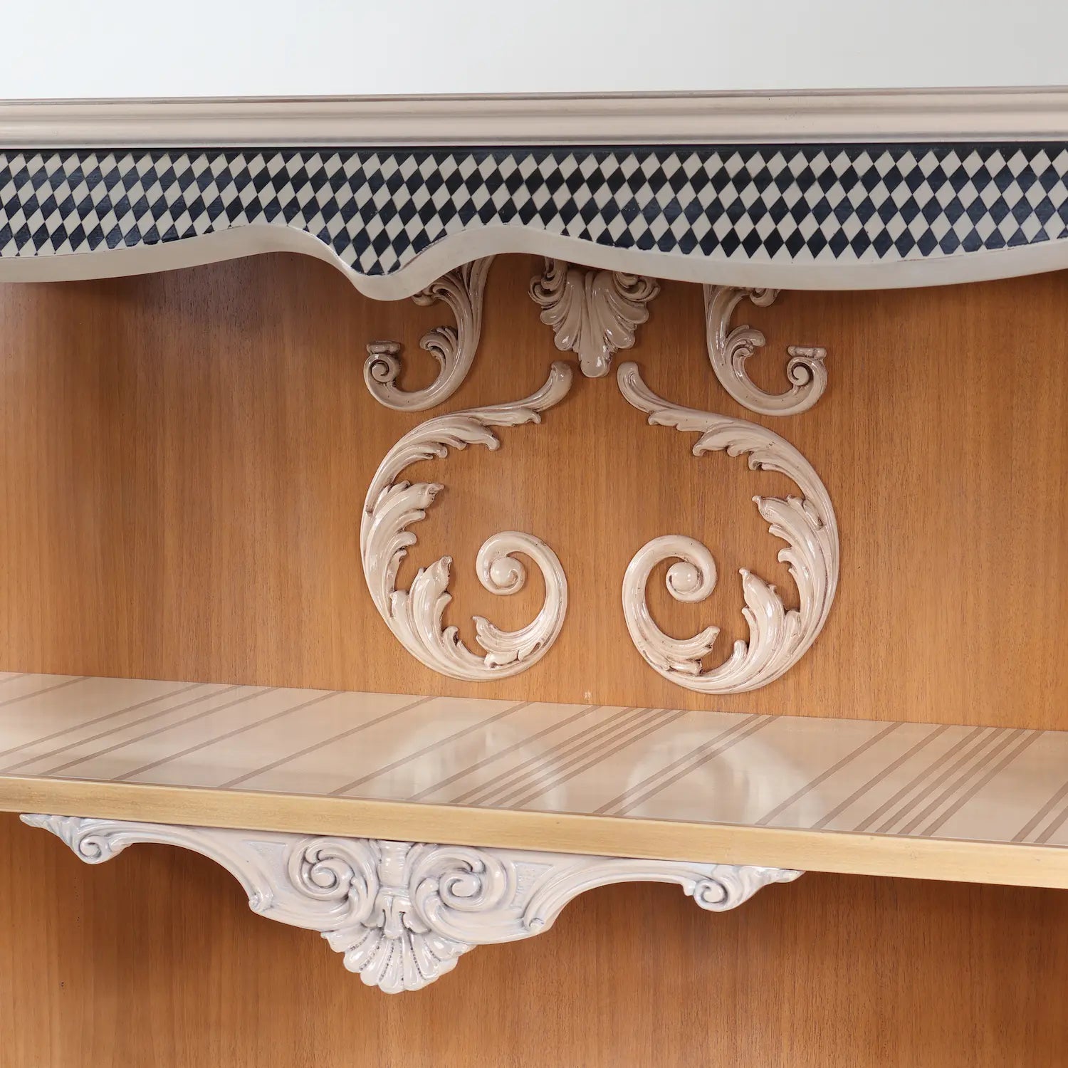 detalle central de librero Arco con ornamentación tallada en madera y acabado clásico
