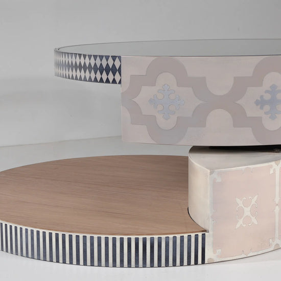 Mesa de centro Annais con composición circular y motivos ornamentales en tonos suaves.