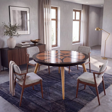Mesa redonda Paolo en comedor contemporáneo con sillas tapizadas y ambiente de diseño premium
