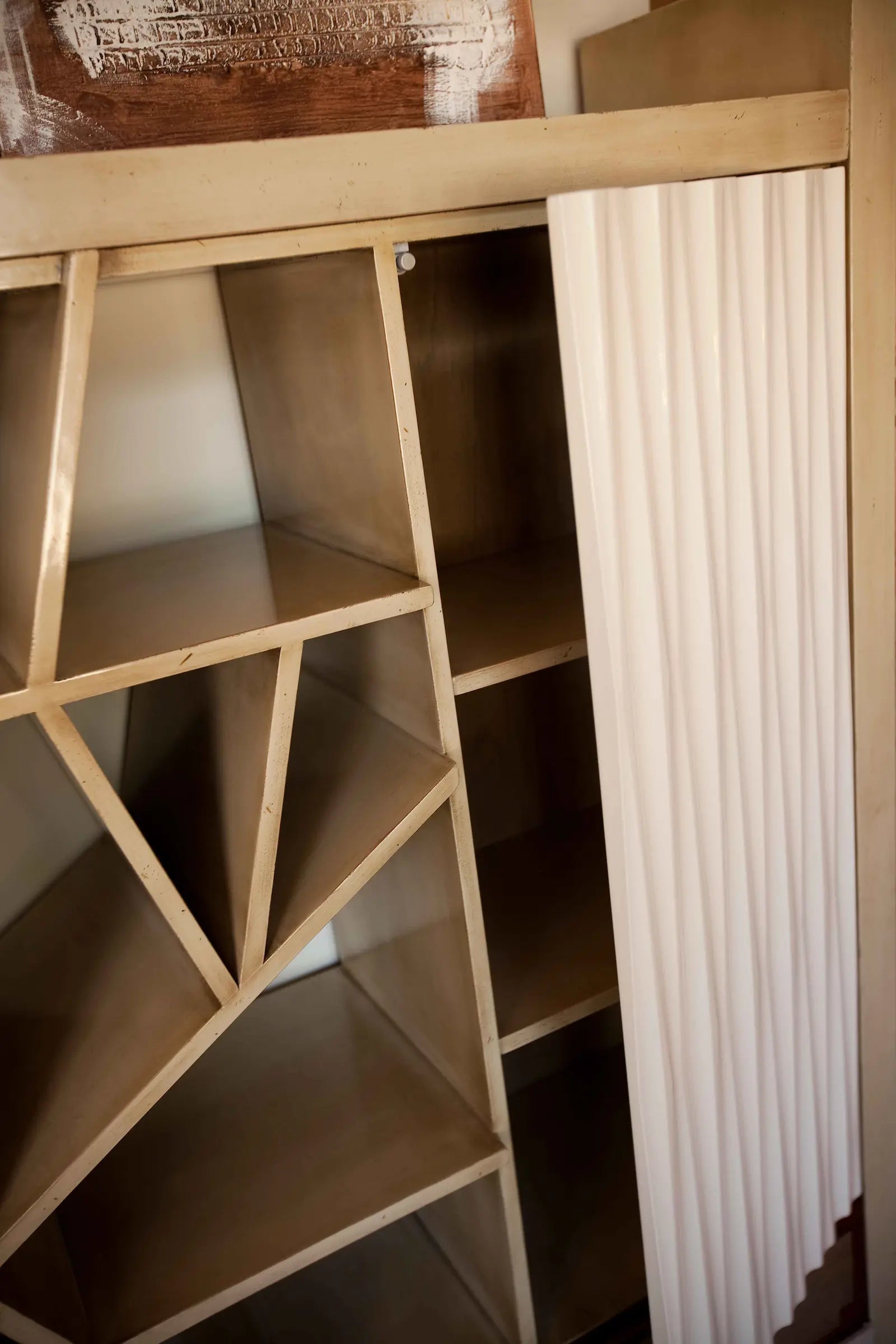Detalle de baldas abiertas y divisiones geométricas del mueble de salón Amore.