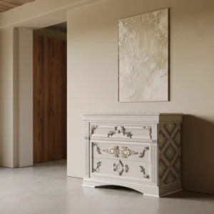 Cómoda Rosette, un mueble de diseño clásico y lujo con dos cajones, molduras doradas y acabado en gris perla.