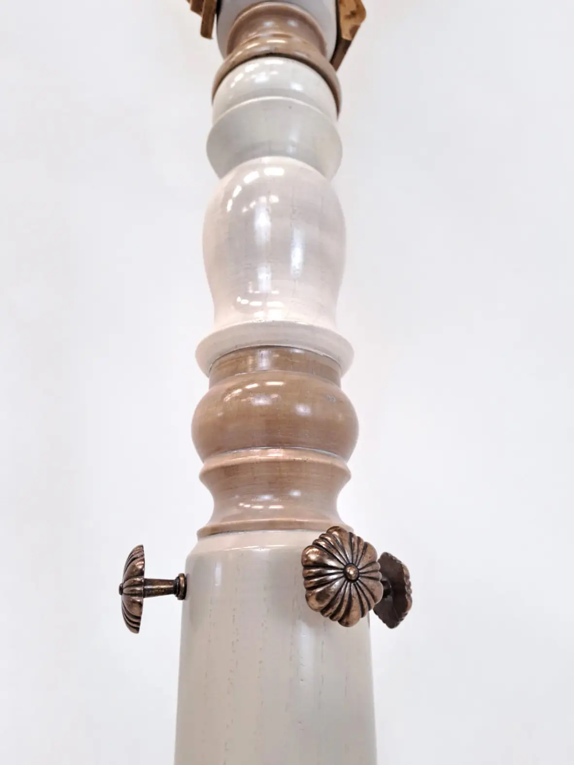 detalle del perchero Cantabile mostrando el tramo central torneado y los adornos metálicos decorativos